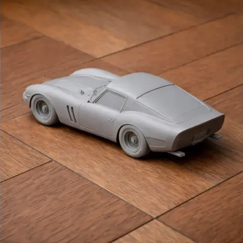 3D printed model of a classic Ferrari 250 GTO car on a wooden surface.