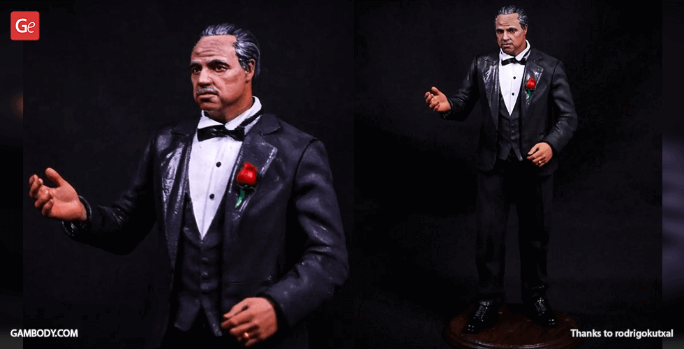 A detailed 3D print model of a suited man with a rose in his lapel, gesturing with one hand.