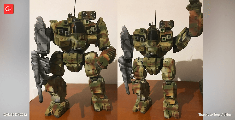 A detailed, painted 3D-printed model of a BattleMaster mech with weapons and antennas on a wooden surface.