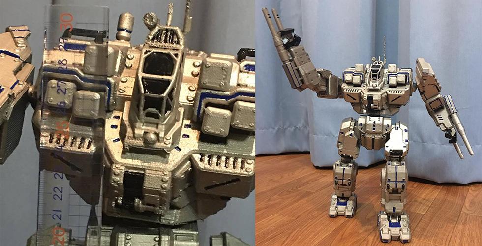 A detailed 3D-printed BattleMech model with articulated arms, painted in metallic colors.