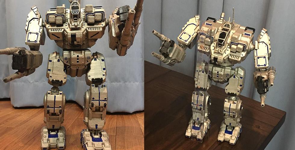 Detailed model of the MWO BattleMaster mech with cannons, painted in metallic tones, posed on a table.