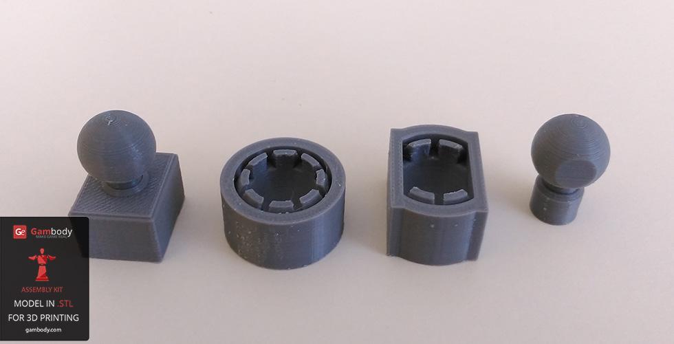 Four 3D-printed parts: two ball-and-socket components and two cylindrical connectors.