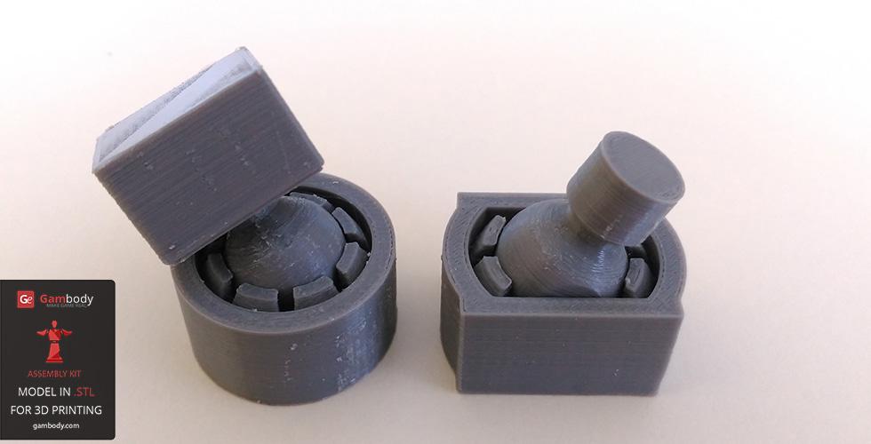 Two 3D-printed, partially assembled circular and square mechanical joints in gray plastic.