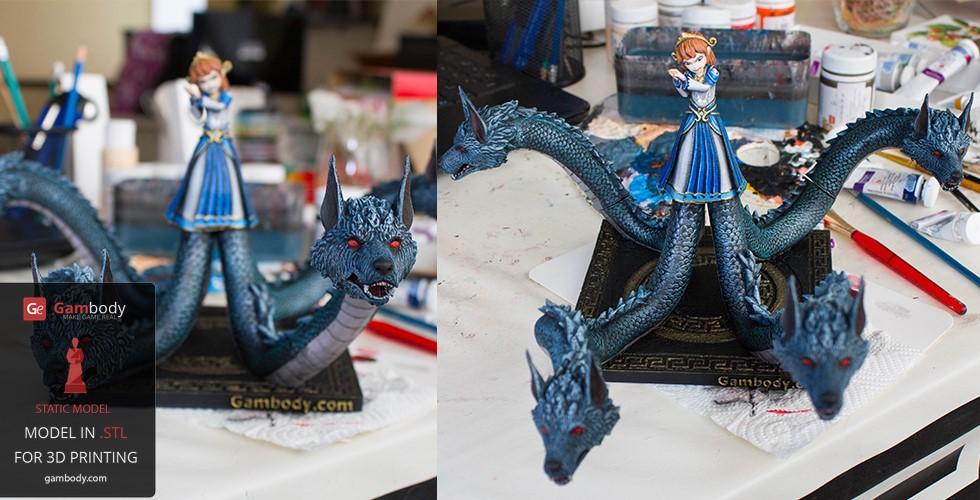 A multi-headed dragon with a girl standing on top, painted and displayed on a crafting table.