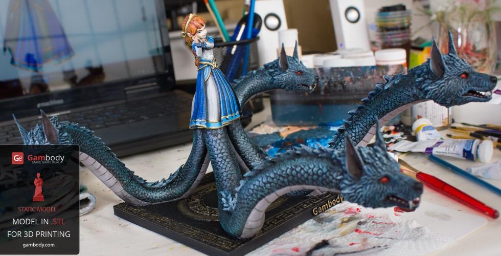 A multi-headed serpent with a human figure on top, set in an art studio environment.