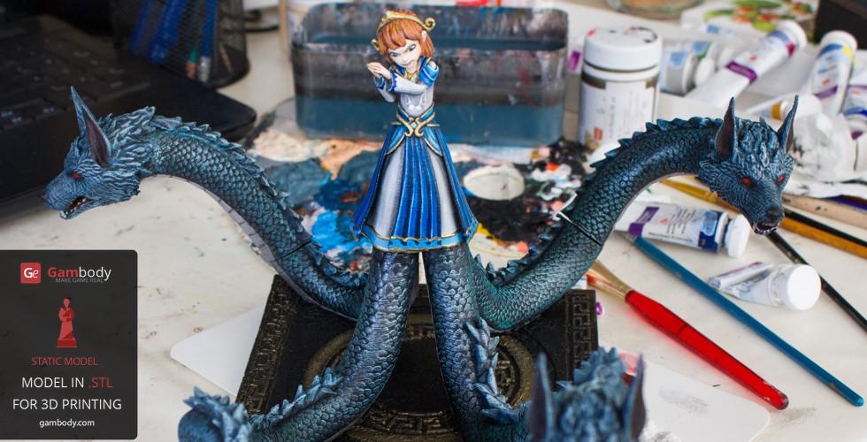 A figure of a woman in a blue dress with three dragon heads on long necks, surrounded by paints.