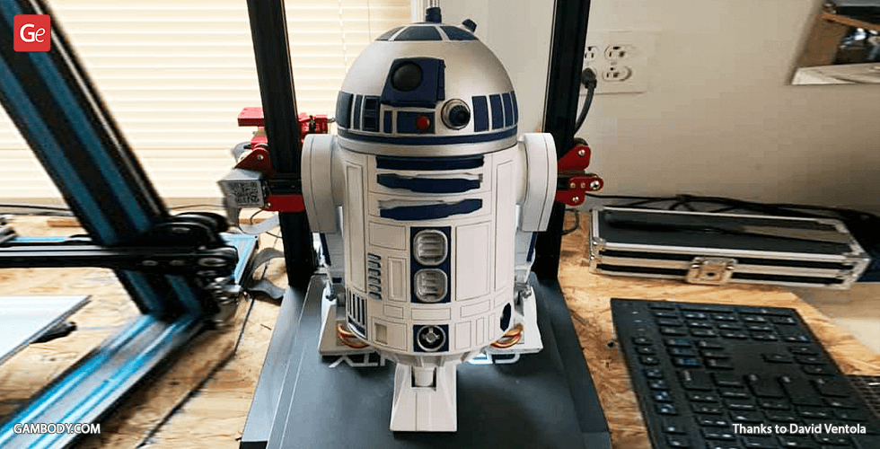 3D printed R2-D2 model on a 3D printer bed, detailed and colorful design.