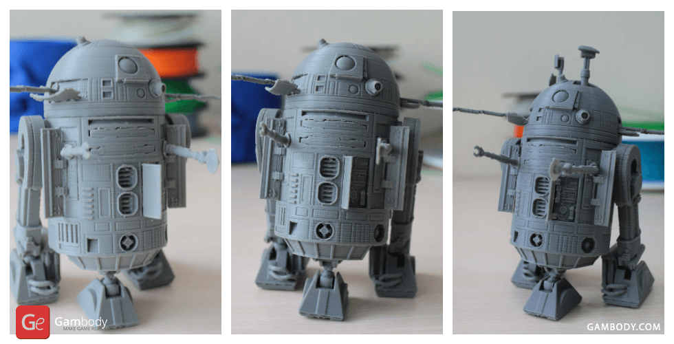 Gray 3D-printed R2-D2 model with detailed features on display from different angles.