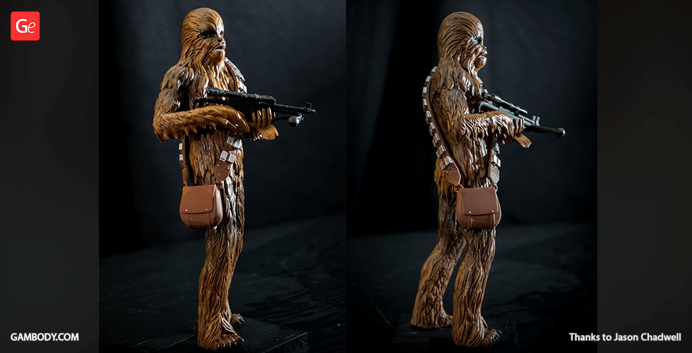 A detailed 3D-printed model of a tall, furry character holding a blaster, with a satchel over the shoulder.