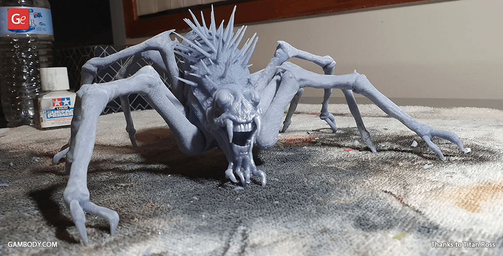 A spiky creature with long, thin legs and a menacing grin on a textured surface.