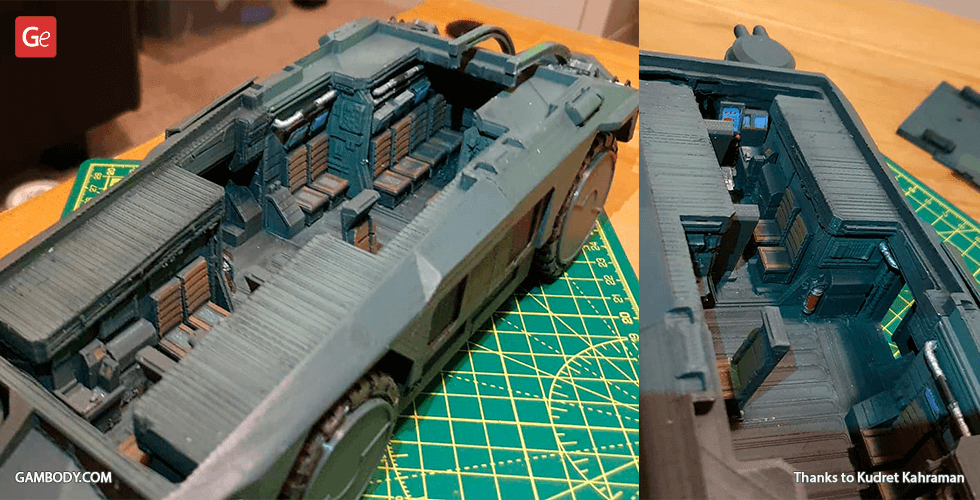 3D printed model of M577 APC with detailed interior and seating, on a cutting mat.